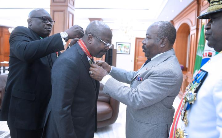 Image de Politique. Le mercredi 19 juillet, le Premier ministre gabonais, Alain Claude Bilie By Nze, a été couronné de la distinction de commandeur dans l'ordre de l'étoile équatoriale par le Président Ali Bongo Ondimba. Certains estiment que cette décoration reflète la confiance du Président envers Bilie By Nze, qui pourrait être chargé de diriger sa campagne pour l'élection présidentielle prévue le 26 août. La campagne électorale débutant le 16 août, cette décoration revêt une signification particulière pour les partisans du président en exercice. Quel est votre avis sur le sujet ?